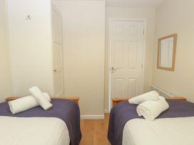 A bedroom with two beds and towels on the beds at 15 The Dell Mundesley