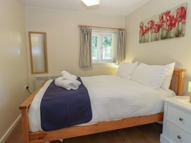 A bedroom with a bed and window at 15 The Dell Mundesley