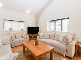 A living room with a sofa and television at Bilsham Meadows in Aust