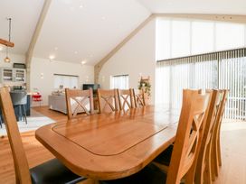 A dining room with a wooden table and chairs at Bilsham Meadows in Aust