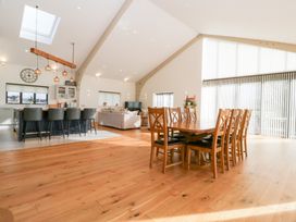 A dining room with a large table and chairs at Bilsham Meadows in Aust