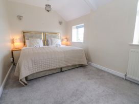 A bedroom with a double bed two bedside tables two lamps and a window at Orme Villa in Llandudno
