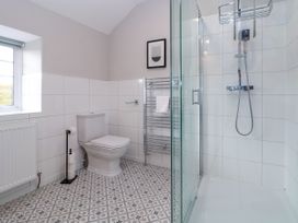 A bathroom with a toilet shower and a radiator at Orme Villa in Llandudno