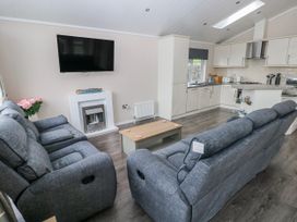 A living room with a sofa and coffee table at Dono's Lodge, Stepaside near Kilgetty, Heritage Park