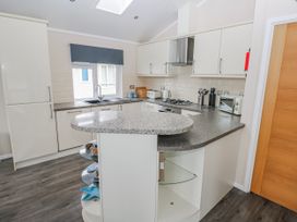 A kitchen with a countertop and appliances at Dono's Lodge, Stepaside near Kilgetty, Heritage Park