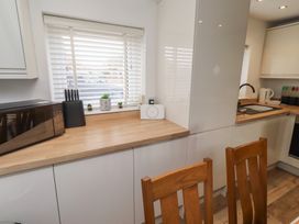 A kitchen with a microwave and sink at 22 Longstone Park Beadnell