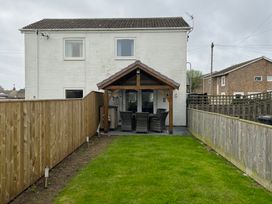 A house with a garden and patio area at 22 Longstone Park Beadnell
