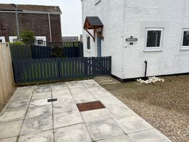 An outdoor area with a fence and pathway at 22 Longstone Park Beadnell