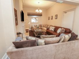 A living room with a sofa and coffee table at The Causeway in Llandudno
