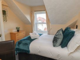 A bedroom with a bed and window at The Causeway in Llandudno