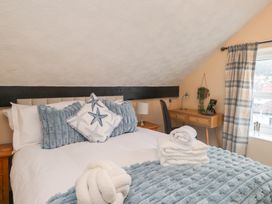 A bedroom with a bed and desk at The Causeway in Llandudno