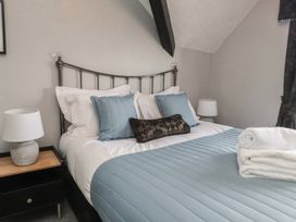 A bedroom with a bed and bedside lamp at The Causeway in Llandudno