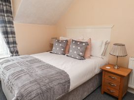 A bedroom with a bed and bedside table at The Causeway Llandudno