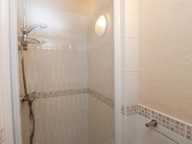 A shower with tiled walls at The Causeway in Llandudno