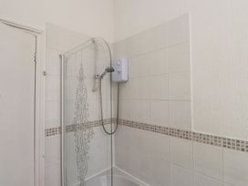 A shower with a glass screen and a showerhead at The Causeway in Llandudno