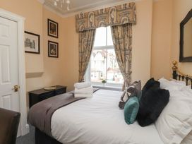 A bedroom with bed and window at The Causeway in Llandudno