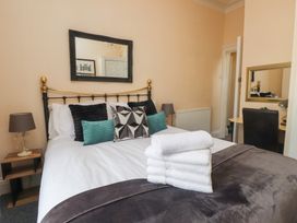 A bedroom with a bed and towels on it at The Causeway in Llandudno