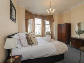 A bedroom with a bed and wardrobe at The Causeway in Llandudno