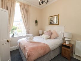 A bedroom with a bed and a window at The Causeway in Llandudno