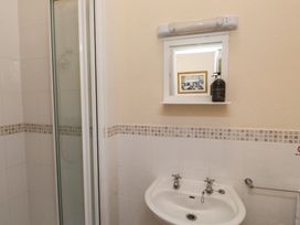 A bathroom with a shower and sink at The Causeway in Llandudno
