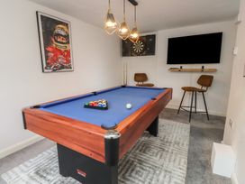 A game room with a pool table and dartboard at The Causeway in Llandudno