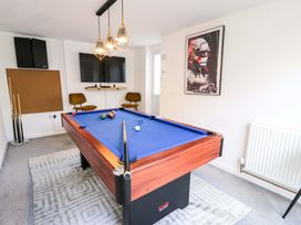 A game room with a pool table and television at The Causeway in Llandudno