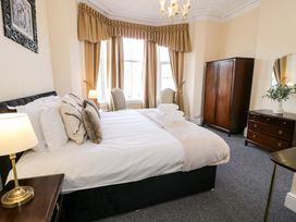 A bedroom with a bed and wardrobe at The Causeway in Llandudno
