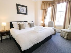 A bedroom with a bed and bedside table at The Causeway in Llandudno