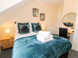 A bedroom with a bed and bedside table at The Causeway in Llandudno