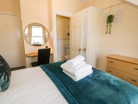 A bedroom with towels on the bed at The Causeway in Llandudno