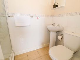 A bathroom with a shower, sink, and toilet at The Causeway in Llandudno
