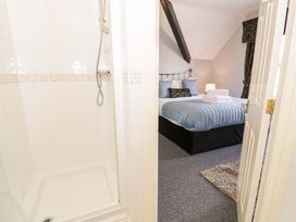 A bedroom with a bed and shower at The Causeway in Llandudno