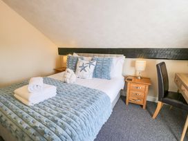 A bedroom with a bed and desk at The Causeway in Llandudno