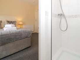 A bedroom with a bed and a shower at The Causeway in Llandudno