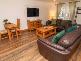 A living room with a television and furniture at 1 Pear Tree Beadnell
