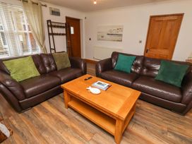 A living room with sofas and a coffee table at 1 Pear Tree in Beadnell
