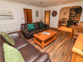 A living room with a sofa and coffee table at 1 Pear Tree Beadnell