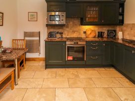 A kitchen with cabinets and appliances at 1 Pear Tree Beadnell