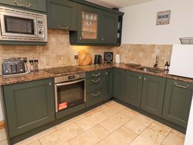 A kitchen with various appliances and cupboards at 1 Pear Tree Beadnell