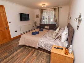 A bedroom with a bed and television at 1 Pear Tree Beadnell