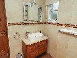 A bathroom with sink and mirror at 1 Pear Tree in Beadnell