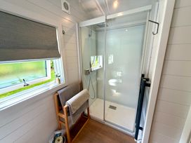 A bathroom with a shower and towel rack at Oh Deer in Ashbourne