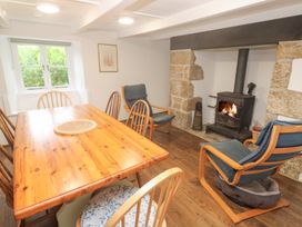A dining room with a table and chairs at Sunnyvale Cottage in Rosudgeon