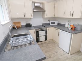 A kitchen with a sink and appliances at Sunnyvale Cottage in Rosudgeon