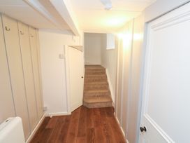 A hallway with stairs and a door at Sunnyvale Cottage in Rosudgeon