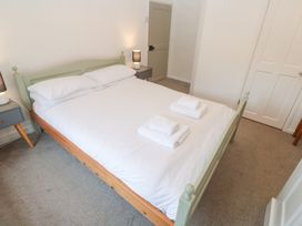 A bedroom with a double bed and nightstand at Sunnyvale Cottage Rosudgeon