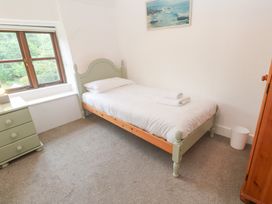 A bedroom with a single bed and dresser at Sunnyvale Cottage Rosudgeon