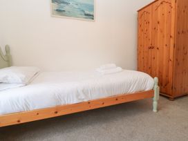 A bedroom with a bed and wardrobe at Sunnyvale Cottage Rosudgeon