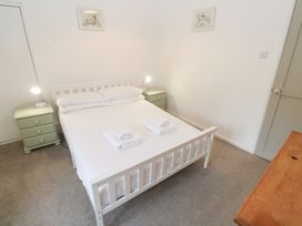 A bedroom with a bed and bedside tables at Sunnyvale Cottage in Rosudgeon