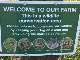 A sign for a wildlife conservation area with various wildlife illustrations at Lonnon Cottage in Alnmouth